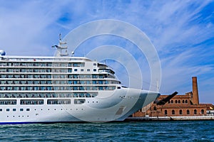 Luxury Cruise Ship Docked by Old Brick Building