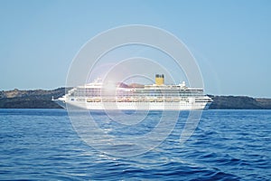 Luxury cruise ship moored in Aegean sea, Greece. Many tourists cruising around Mediterranean sea to explore beautiful Greek