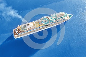 Luxury cruise ship sailing across the sea aerial view