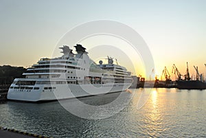 Luxury cruise ship sailing to port on sunrise