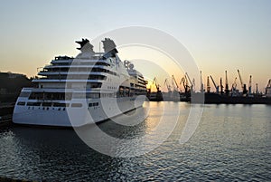 Luxury cruise ship sailing to port on sunrise