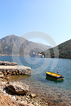 Luxury cruise ship and small boat at sea