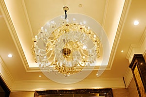Luxury crystal chandelier in hotel hall photo