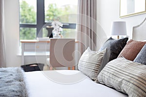 Luxury Cushions on a Crisp White Linen Bed.