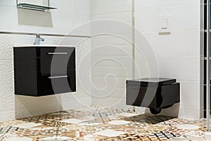 Luxury design of bathroom with black toilet bowl and washbasin