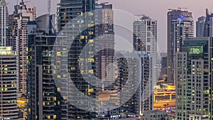 Luxury Dubai Marina canal with passing boats and promenade day to night timelapse, Dubai, United Arab Emirates