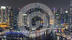 Luxury Dubai Marina canal with passing boats and promenade night timelapse, Dubai, United Arab Emirates