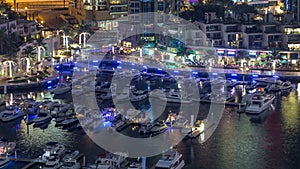 Luxury Dubai Marina canal with passing boats and promenade night timelapse, Dubai, United Arab Emirates