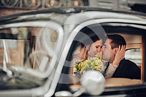 Luxury elegant wedding couple kissing and embracing in stylish b