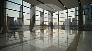 Luxury empty restaurant in Dubai during sunset. Dolly in view of tall skyscrapers in city center of Dubai from large