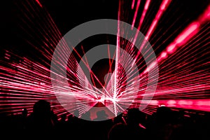 Red laser show nightlife club stage with party people crowd