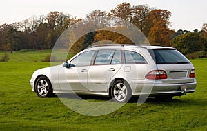 Luxury estate (wagon) car parked on grass