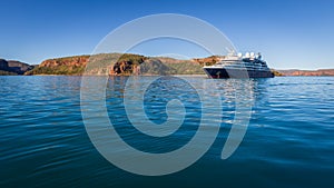 An luxury expedition cruise ship at anchor in the late afternoon in Prince Frederick Harbor on the remote North West Coast of the