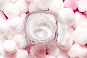 Luxury face cream for sensitive skin and pink cotton balls on background, spa cosmetics and natural skincare beauty brand product