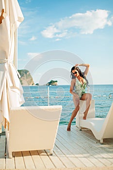 Luxury fashion bikini model on sunbed chill out