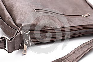 Luxury fashion women leather bronze handbag isolated on a white background.