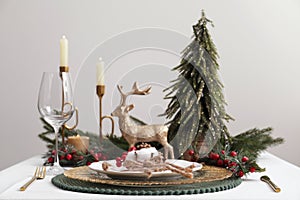 Luxury festive place setting with beautiful decor for Christmas dinner on white table, closeup