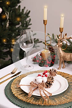 Luxury festive place setting with beautiful decor for Christmas dinner on white table indoors