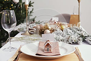 Luxury festive place setting with blank card and beautiful decor for Christmas dinner on white table indoors