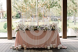 Luxury floristics and elegantly decorated groom and bride table