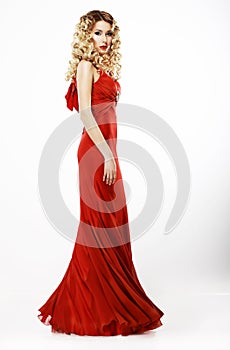 Luxury. Full Length of Elegant Lady in Red Satiny Dress. Frizzy Blond Hair