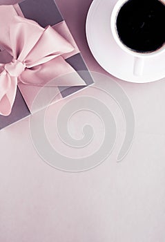 Luxury gift box and coffee cup on blush pink background, flatlay design for romantic holiday and birthday surprise