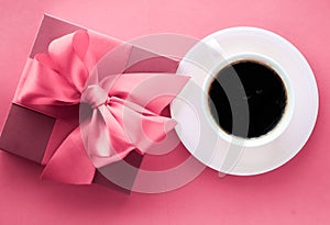 Luxury gift box and coffee cup on pink background, flatlay design for romantic holiday morning surprise