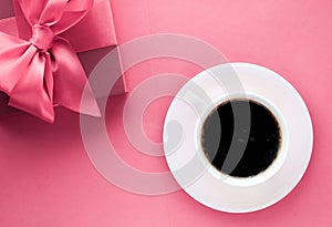 Luxury gift box and coffee cup on pink background, flatlay design for romantic holiday morning surprise