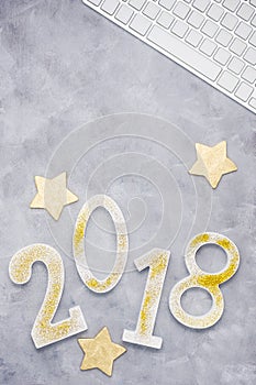 Luxury glitter numbers 2018 with keyboard and gold stars on grey background