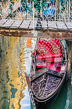 Luxury gondola under bridge, Venice, Italy