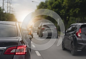 Luxury of gray car with open brake light and stop on the asphalt road.