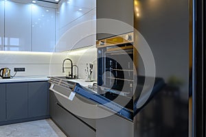 Luxury gray modern kitchen interior, oven's door opened