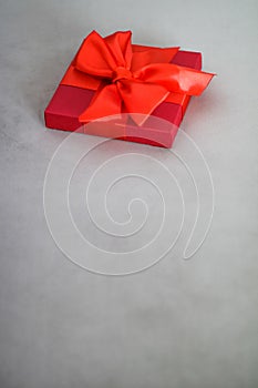 Luxury holiday red gift box with silk ribbon and bow, christmas or valentines day decor