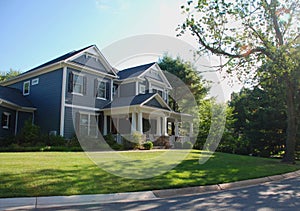 Luxury Home With Blue Siding and White Columns