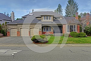 Luxury home exterior with three car garage.