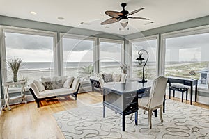 Luxury home office with large windows and a view of the ocean