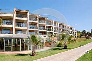 The luxury hotel building and palm trees