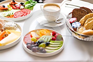 Luxury hotel and five star room service, various food platters, bread and coffee as in-room breakfast for travel and