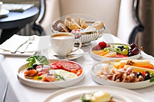 Luxury hotel and five star room service, various food platters, bread and coffee as in-room breakfast for travel and