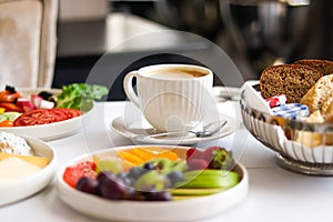 Luxury hotel and five star room service, various food platters, bread and coffee as in-room breakfast for travel and