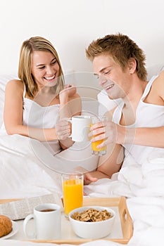 Luxury hotel honeymoon breakfast - couple in bed