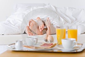 Luxury hotel honeymoon breakfast - couple in bed photo