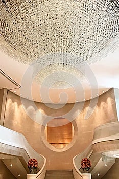 Luxury hotel lobby, staircase and huge crystal lamp