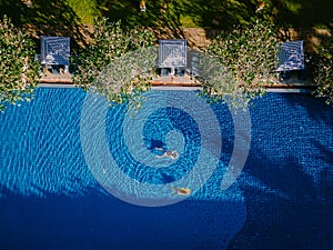 Luxury hotel swimming pool, Beautiful tropical beach and sea with umbrella and chair around swimming pool in hotel