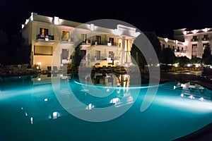 Luxury hotel view with big pool, at night