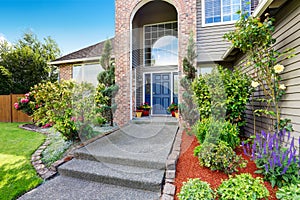 Luxury house with brick and siding trim, concrete floor porch.