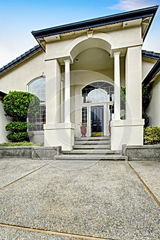 Luxury house entry way exterior with concrete floor porch.