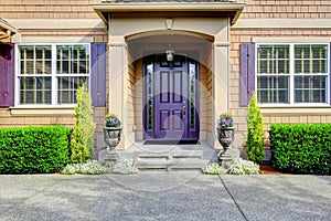 Luxury house exterior. Entrance porch with purple door