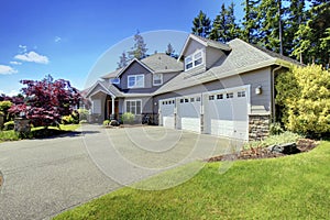 Luxury house exterior with french windows and three space parking garage.