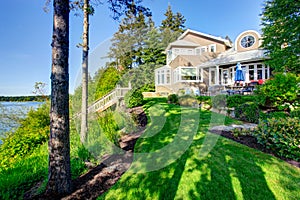 Luxury house exterior with impressive backyard landscape design.